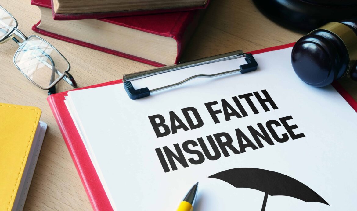 Clipboard with bad faith insurance document, gavel, and legal books on lawyer’s desk.