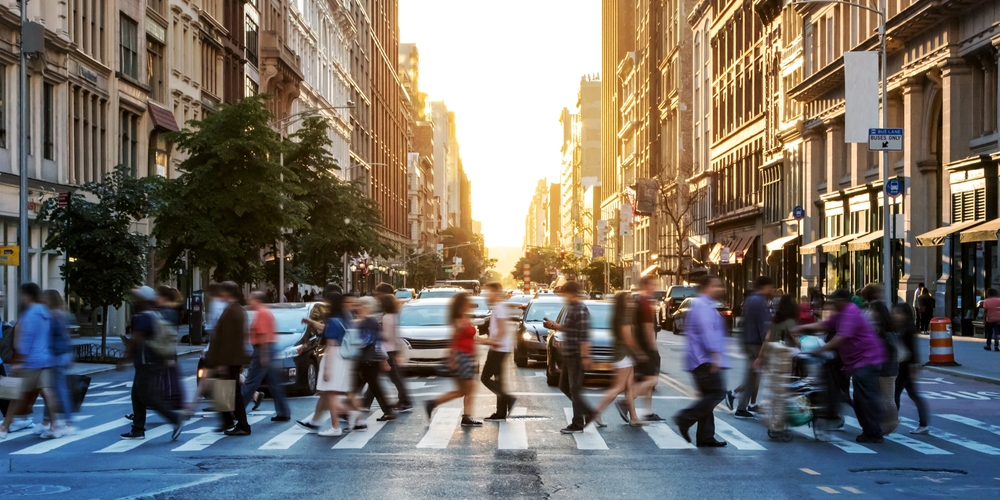 Busy city crosswalk with pedestrians and cars at sunset, representing urban traffic and pedestrian safety. Busy city crosswalk with pedestrians and cars at sunset, representing urban traffic and pedestrian safety.