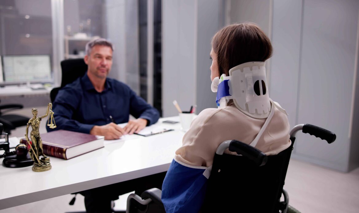 Injured woman in neck brace and wheelchair meeting with personal injury lawyer in office.