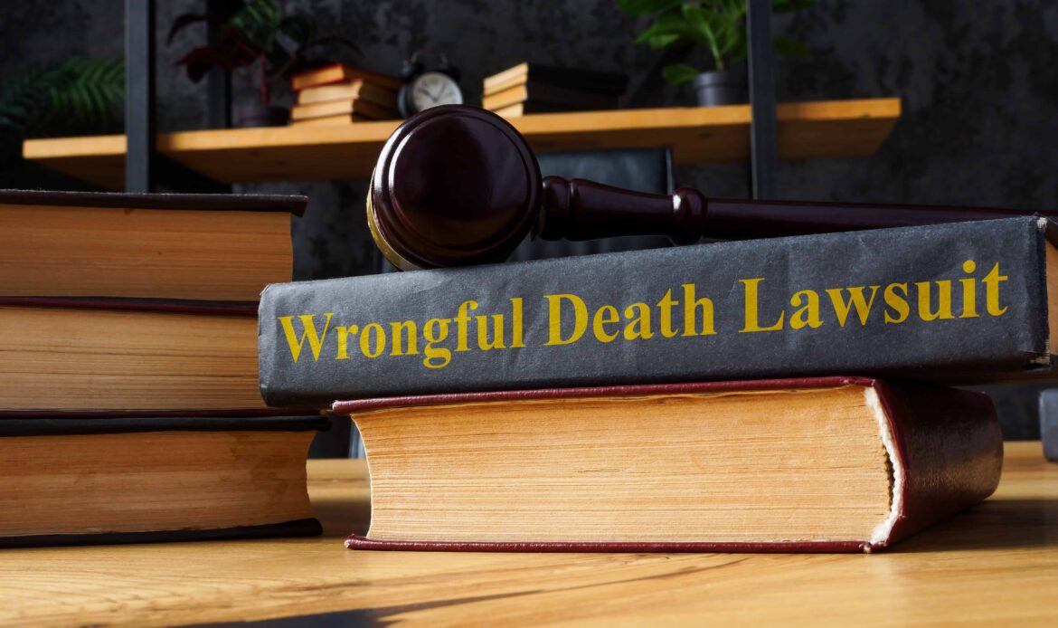 Gavel resting on a legal book titled Wrongful Death Lawsuit on lawyer’s desk in office. Gavel resting on a legal book titled Wrongful Death Lawsuit on lawyer’s desk in office.
