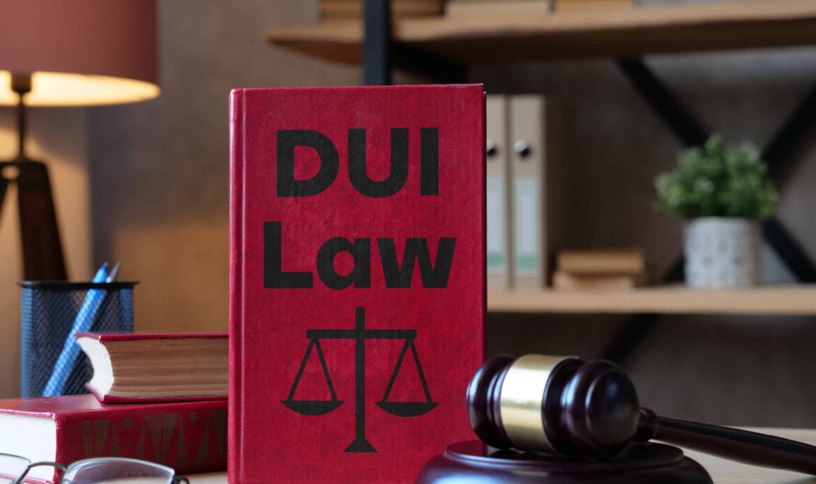 DUI law book with judge’s gavel on a lawyer’s desk representing drunk driving legal defense. DUI law book with judge’s gavel on a lawyer’s desk representing drunk driving legal defense.