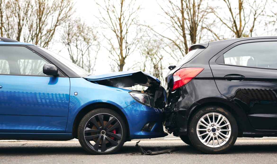 Rear-end collision between two cars showing front-end damage to a blue vehicle and back-end damage to a black vehicle.