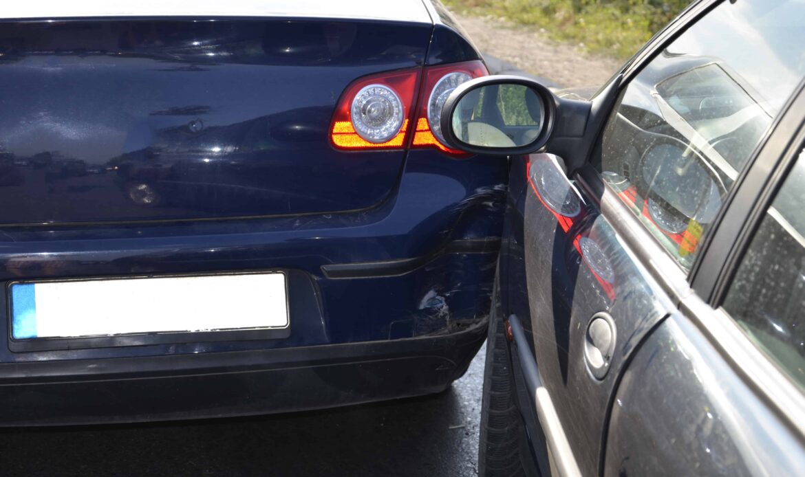 Two cars involved in a sideswipe collision, showing visible damage where the vehicles scraped against each other.