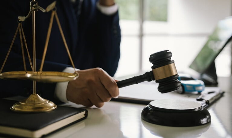 Personal injury attorney holding gavel during legal settlement negotiation