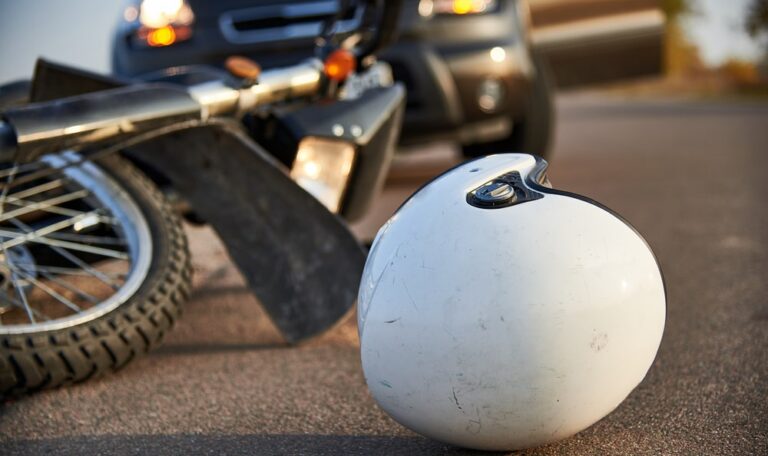 Motorcycle helmet on road after crash involving car