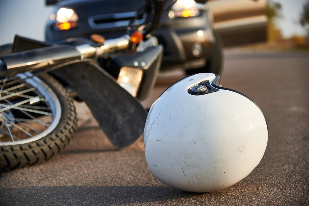 Motorcycle helmet on road after crash involving car