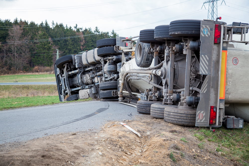 Overturned 18 wheeler illustrating costly damages after truck accident