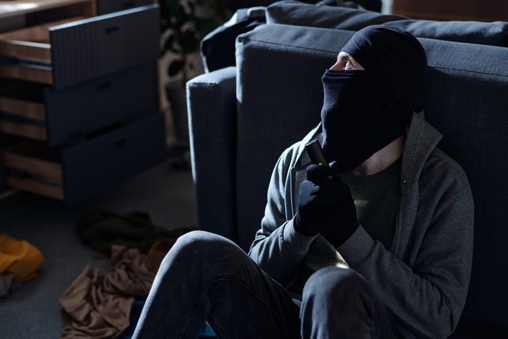 Criminal inside building illustrating negligent security claim against property owner in Texas