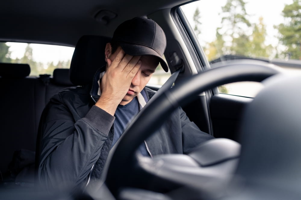 Impaired young driver inside vehicle illustrating underage DUI accident liability in Colorado