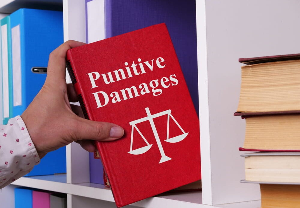 Alcohol drink next to judge gavel representing punitive damages for drunk driving in Colorado