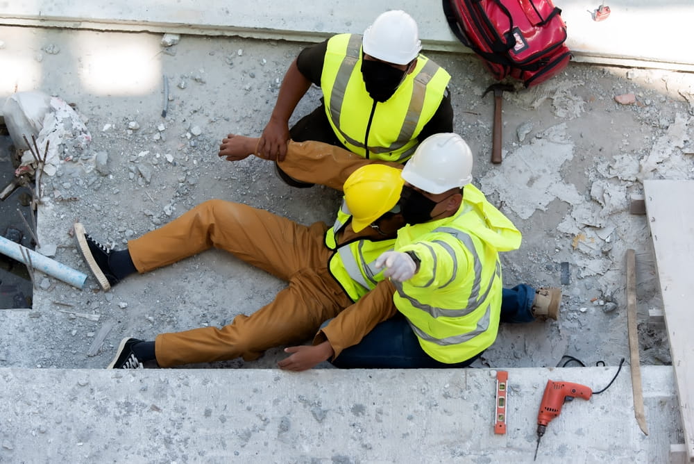 Construction workers helping injured colleague illustrating personal injury claim in Texas construction accident