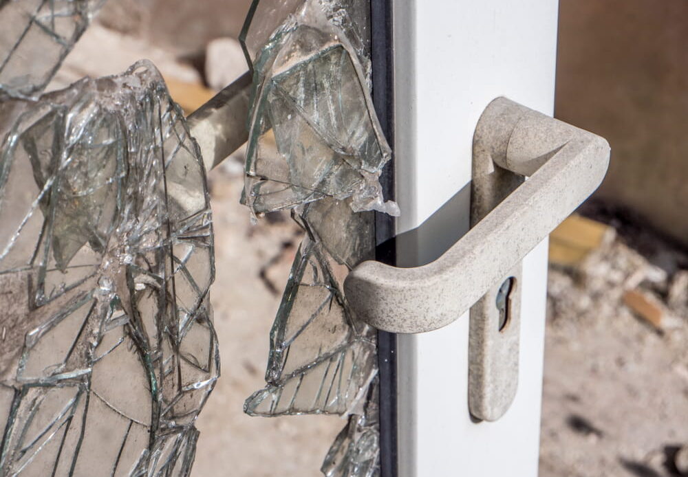 Broken entry door showing inadequate security on government property in Texas
