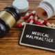Gavel and prescription pills representing medical negligence and malpractice claims in Texas