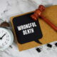 Gavel and sign reading wrongful death representing a legal claim filed by family members after a fatal accident in Texas