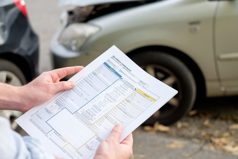 Person reviewing a car accident report after a crash in Grand Junction