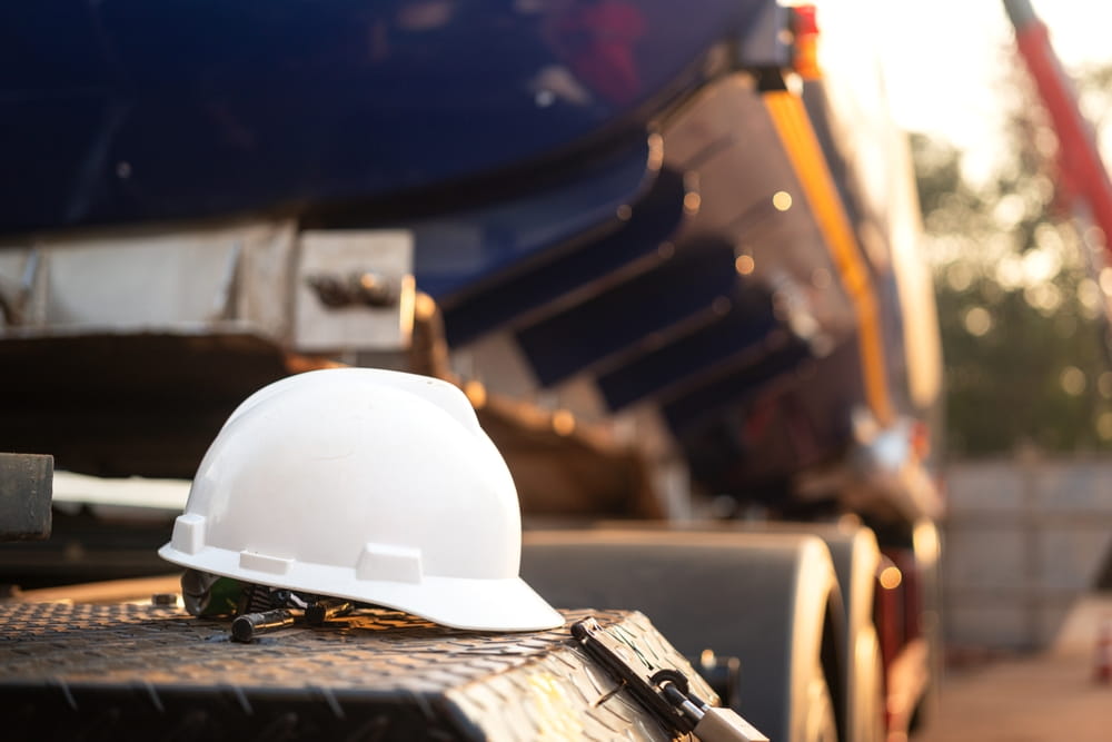 Struck-By Construction Hazards Hard hat near heavy equipment illustrating struck-by hazards on construction sites