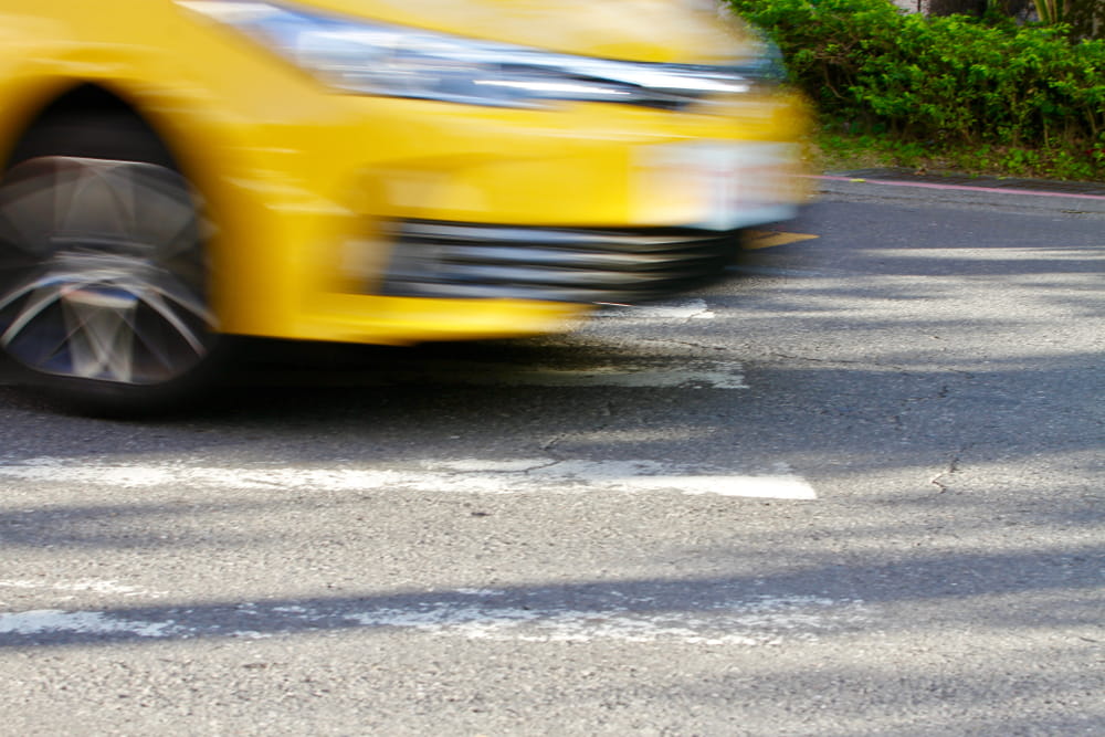 Speeding vehicle in motion blur representing a rideshare accident risk