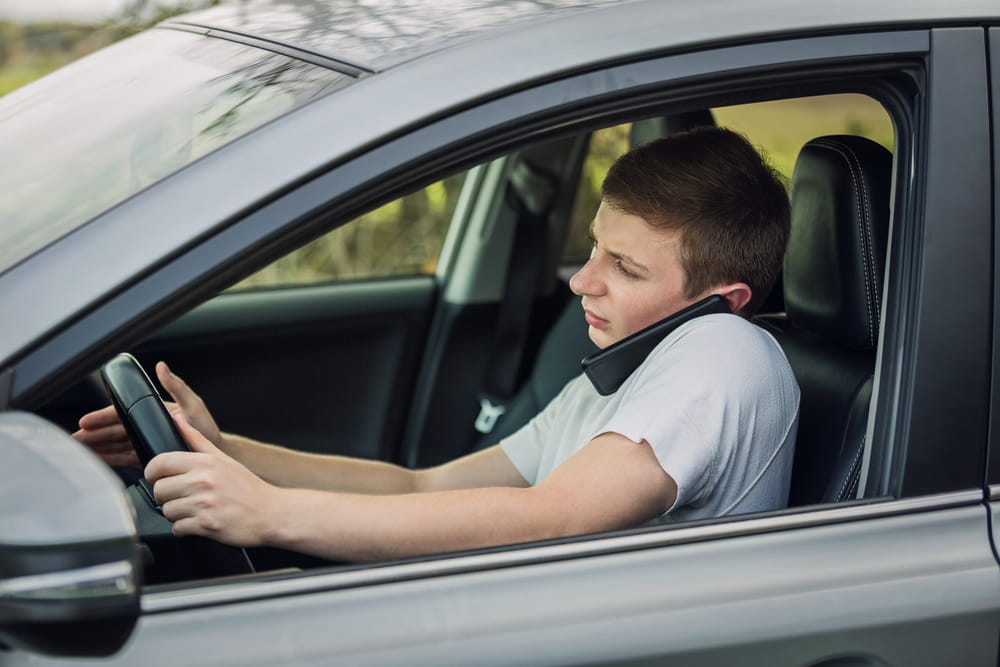 Distracted driver using a phone while driving, a common factor in rideshare accident disputes