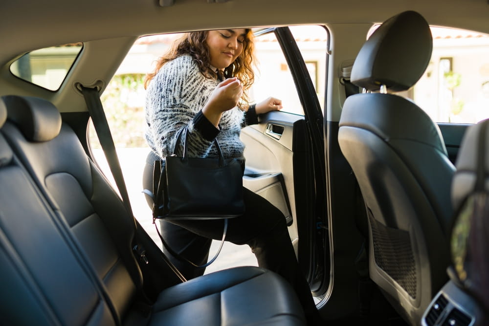 Passenger getting into a rideshare vehicle in Austin during a trip