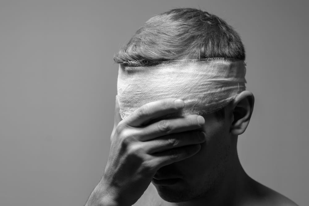 Man with a bandaged head after a traumatic brain injury