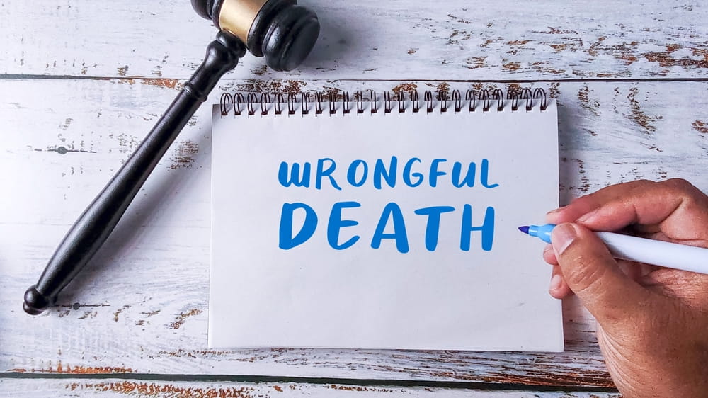 Wrongful death notepad beside a gavel representing a Colorado wrongful death claim
