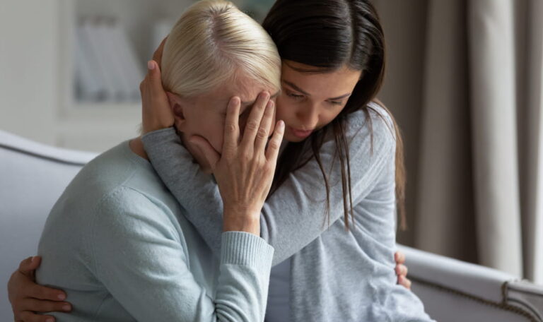 Woman comforting a grieving family member after a wrongful death