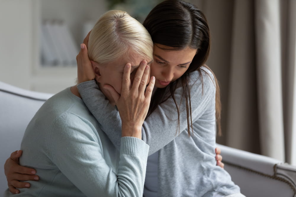 Woman comforting a grieving family member after a wrongful death