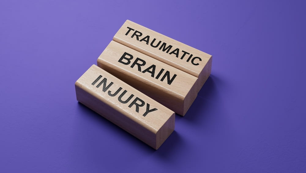 Wooden blocks spelling traumatic brain injury for a Colorado concussion claim article