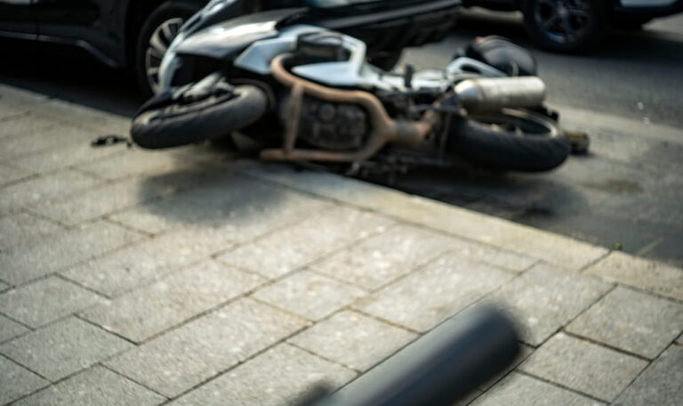 Motorcycle lying in the road after a Grand Junction crash