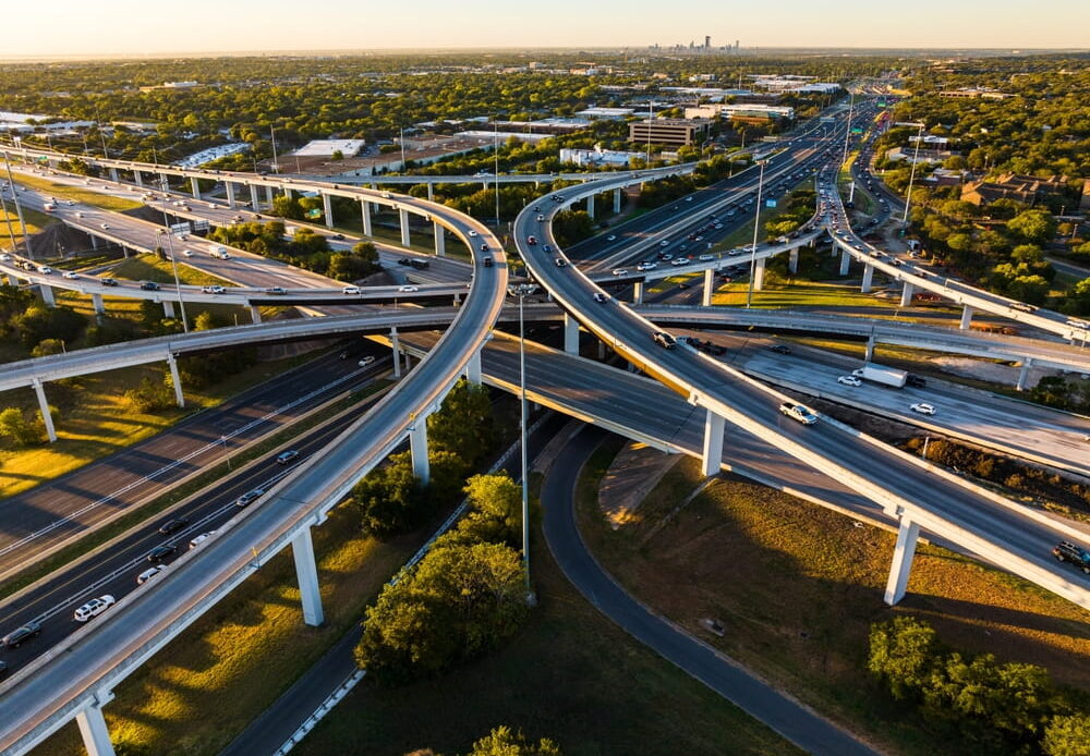 Aerial view of a multi-level highway interchange representing SH-130 and I-35 traffic corridors
