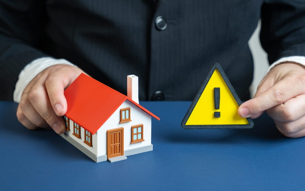 House model and warning sign representing a property hazard under Texas premises liability law