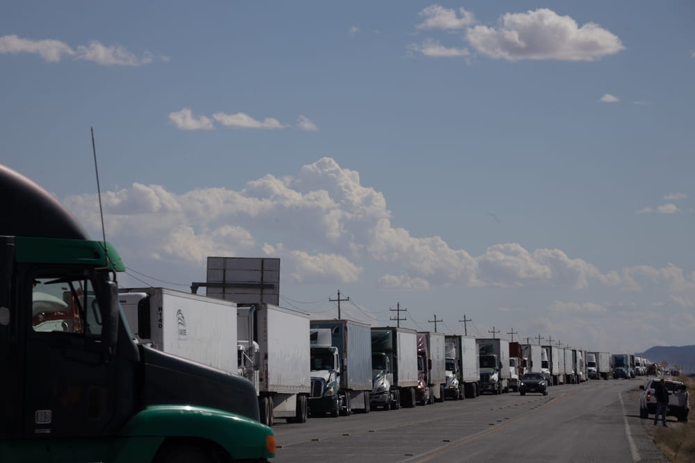 Line of commercial trucks stopped along a highway