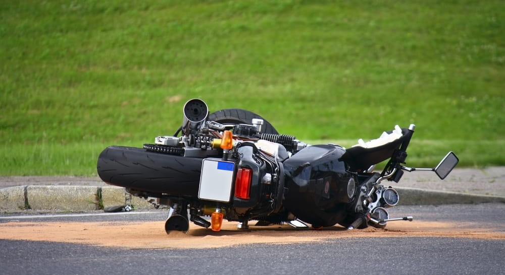 Motorcycle wreckage on the roadside after an accident
