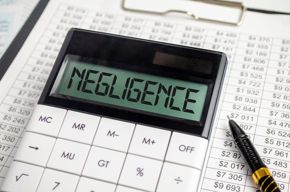 Calculator displaying the word "negligence" on a spreadsheet of dollar figures
