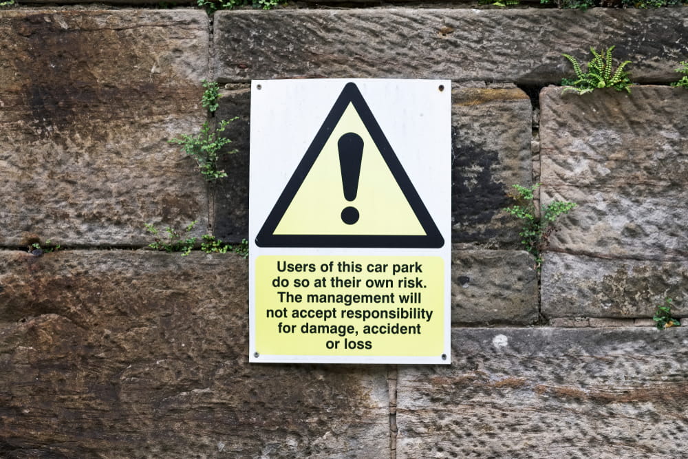 Warning sign disclaiming property owner responsibility for accidents