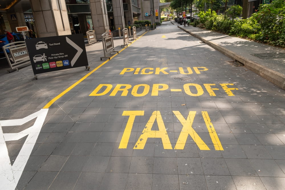 Designated pickup and drop-off zone signage for rideshare and taxi services