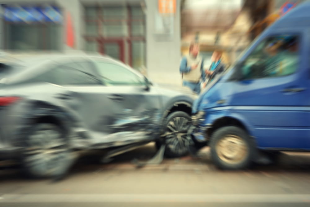 Vehicle collision on a city street involving a car and van