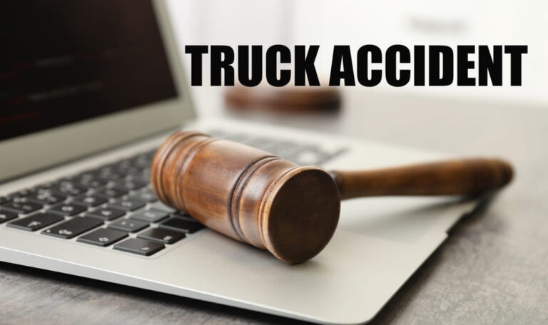 Gavel resting on a laptop with the words "truck accident"