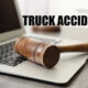 Gavel resting on a laptop with the words "truck accident"