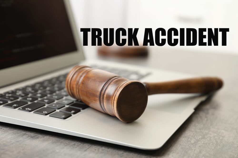 Truck Accident Legal Claims Gavel resting on a laptop with the words "truck accident"