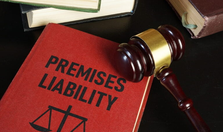 Law book titled "Premises Liability" next to a judge's gavel