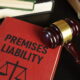 Law book titled "Premises Liability" next to a judge's gavel