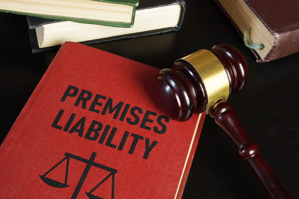 Law book titled "Premises Liability" next to a judge's gavel