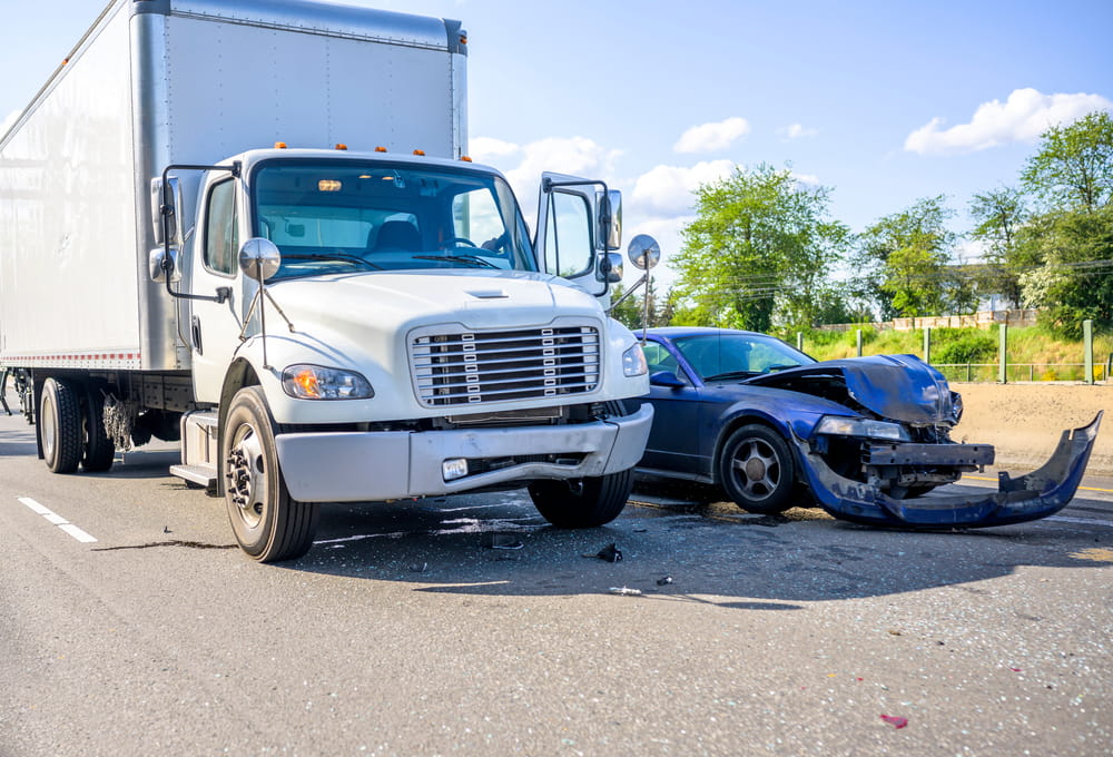 Commercial truck collision with a passenger car on the roadway