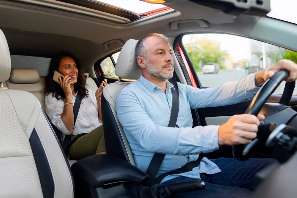 Rideshare driver and passenger in a vehicle during a trip