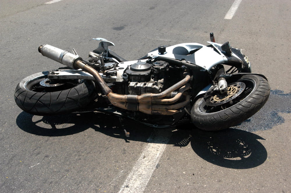 Wrecked motorcycle lying on the roadway after a crash