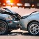 Two vehicles with front-end collision damage on a street
