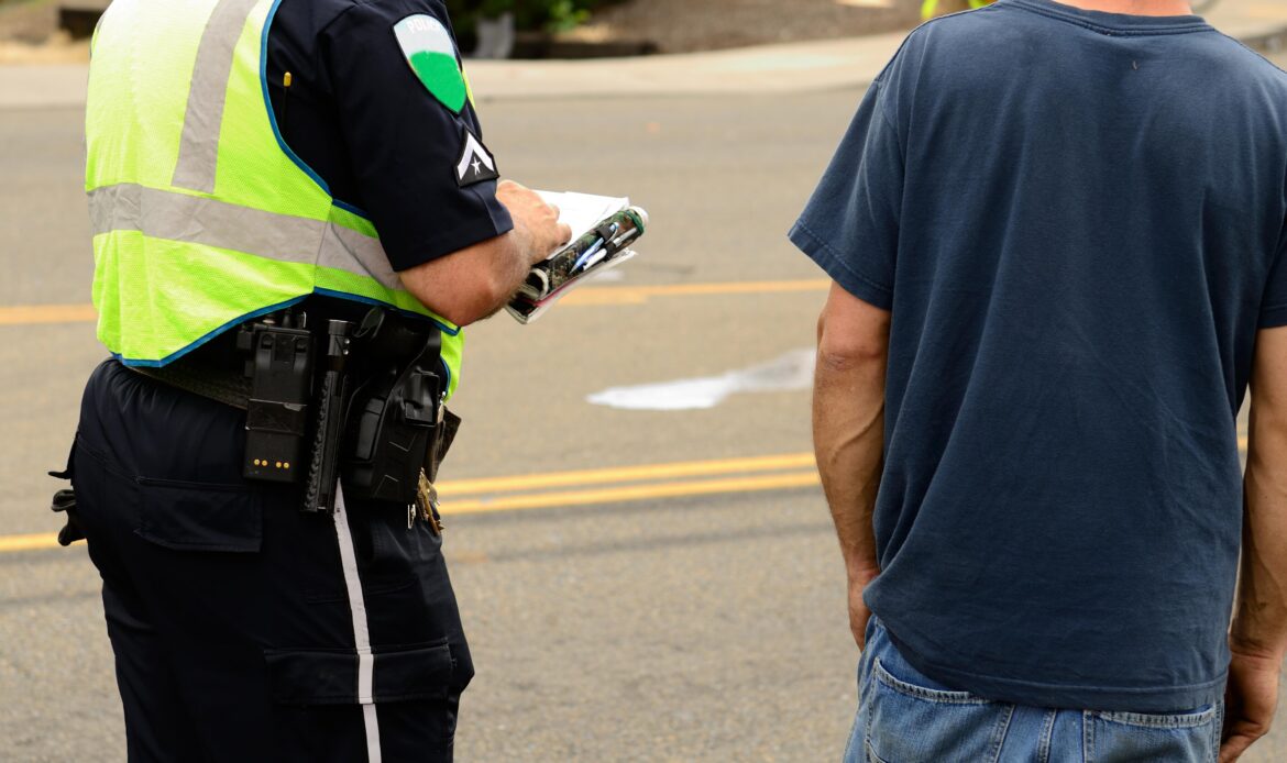 police officer writing report roadside american